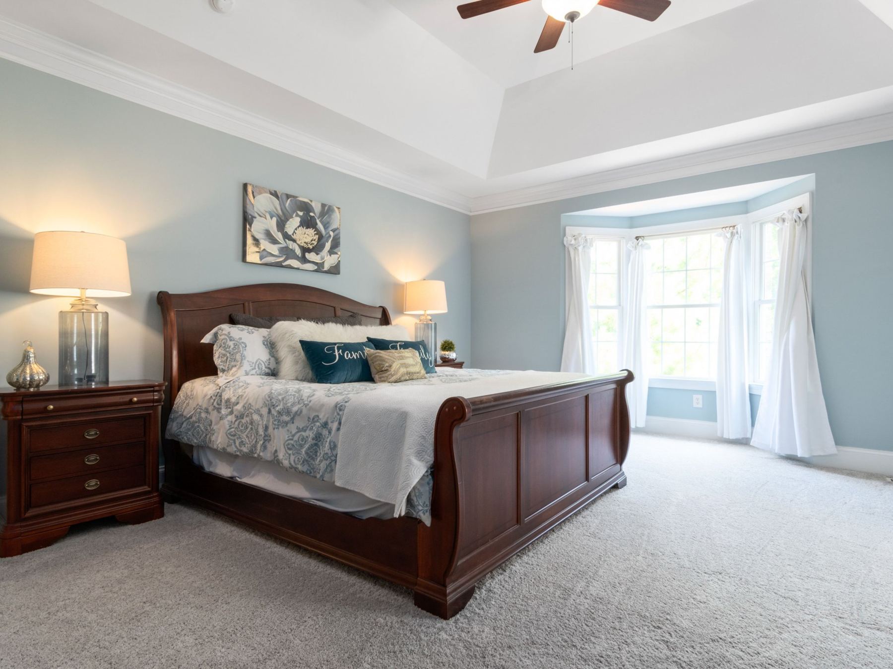 Bedroom with pale blue walls and white trim